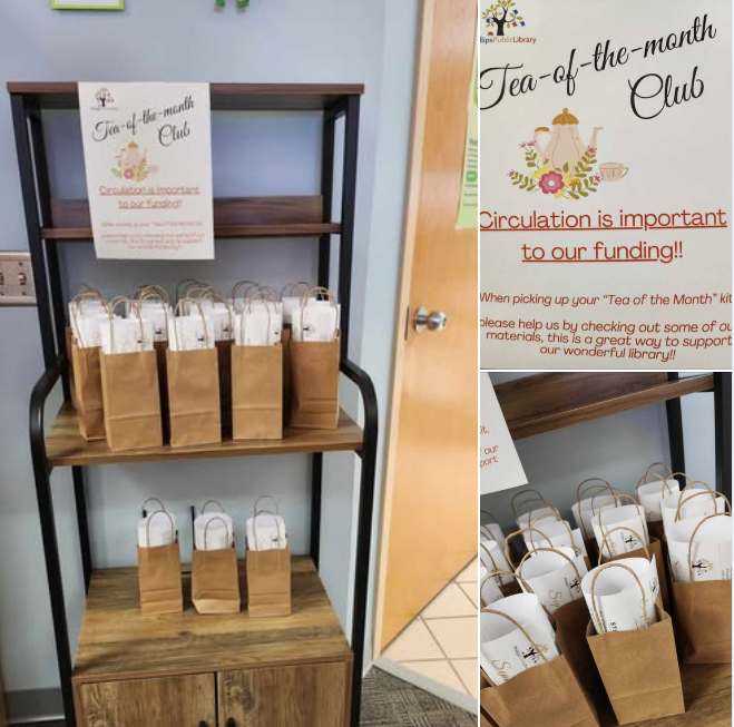 brown paper bags on a cart with sign explaining tea of the month